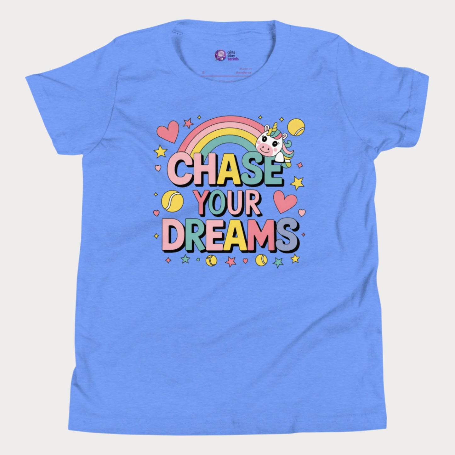 Adorable girls' blue tennis t-shirt featuring a cute unicorn, colorful rainbow, and "Chase Your Dreams" slogan with tennis ball accents.