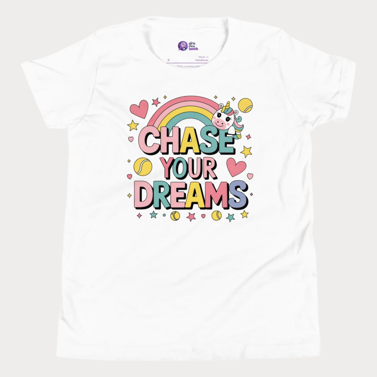 Adorable girls' tennis t-shirt featuring a cute unicorn, colorful rainbow, and "Chase Your Dreams" slogan with tennis ball accents.