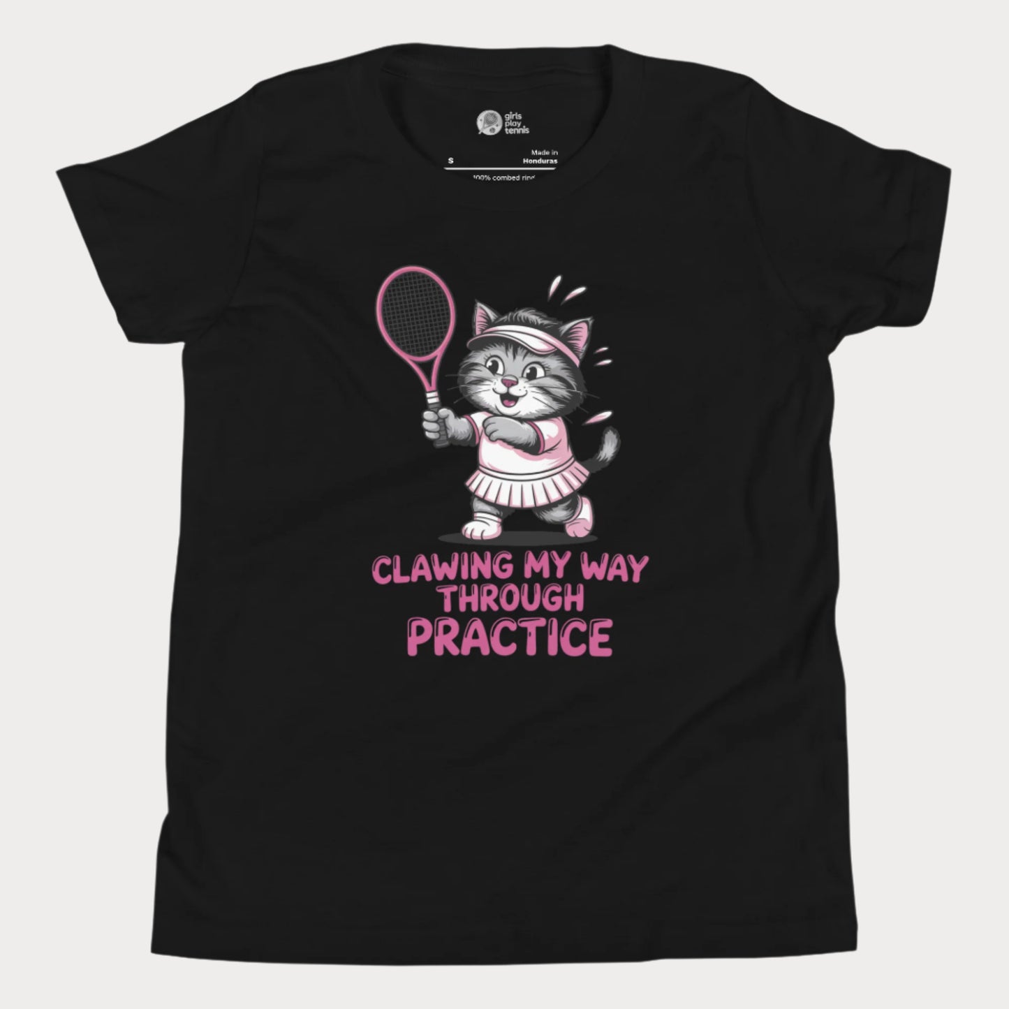 A black girls’ tennis t-shirt featuring a determined gray kitten in a pink tennis outfit holding a pink tennis racket. The kitten is sweating and focused, with the phrase “Clawing My Way Through Practice” in bold pink lettering underneath.
