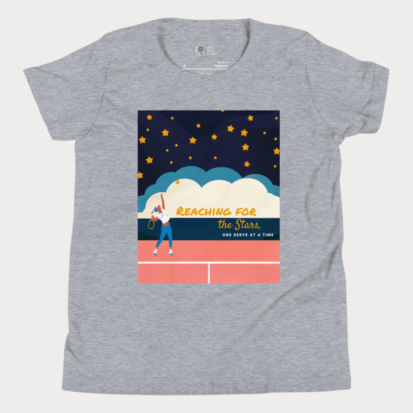 Grey girls' tennis T-shirt featuring a motivational design of a young girl serving on a tennis court under a starry sky, with the phrase "Reaching for the Stars, One Serve at a Time." Perfect for young tennis players who dream big.