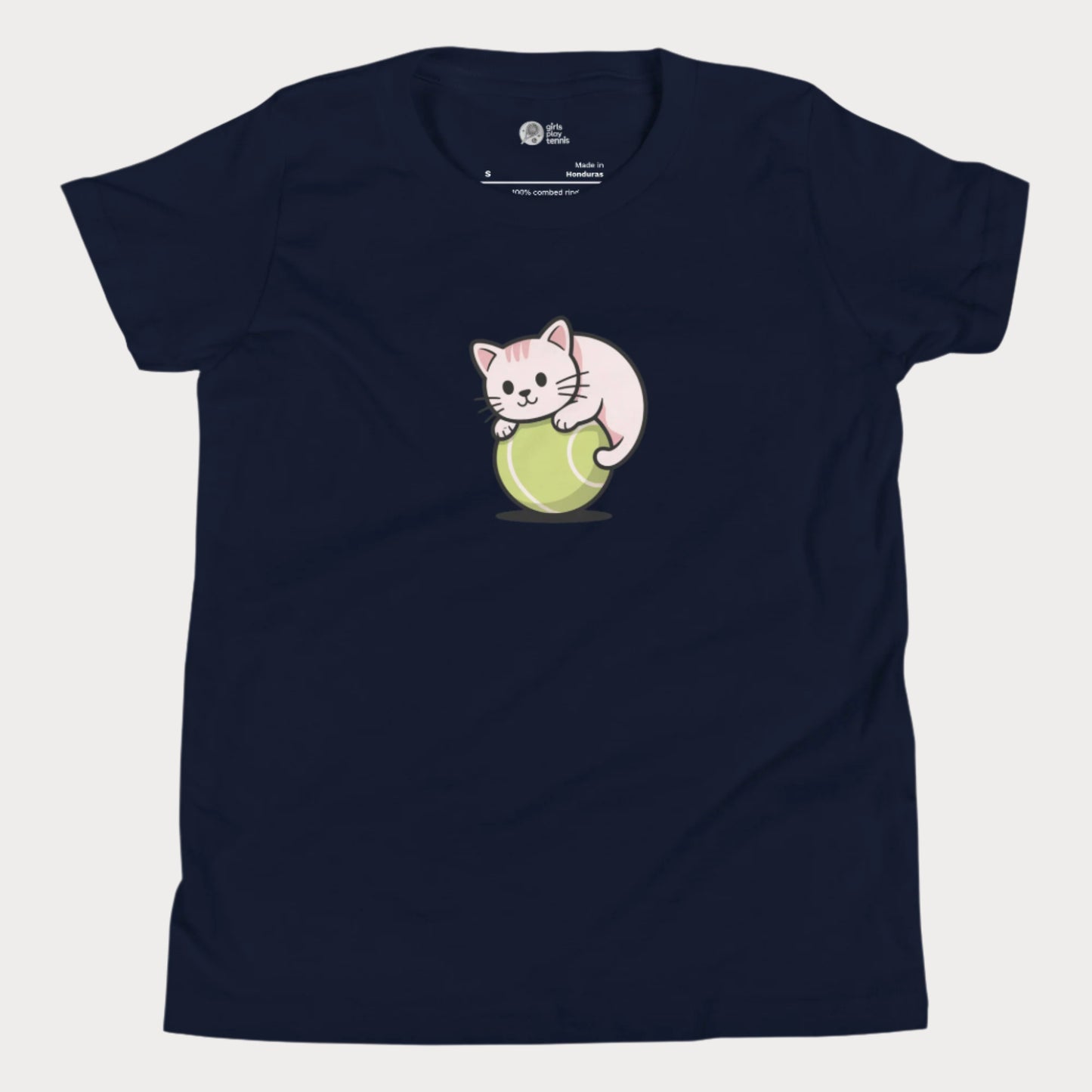 Navy girls’ tennis t-shirt featuring a cute kitten playfully curled around a bright green tennis ball in the center of the chest — a fun and whimsical design perfect for young tennis players who love animals and the game.