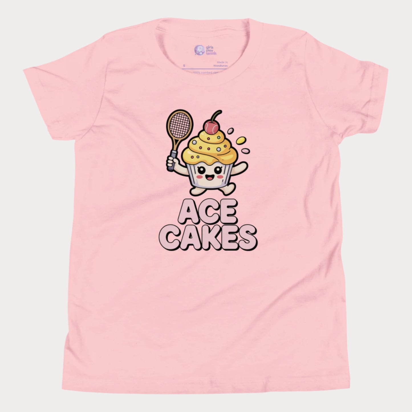 Pink girls tennis t-shirt with a cartoon cupcake character holding a tennis racket and the text 'ACE CAKES' on a white background.