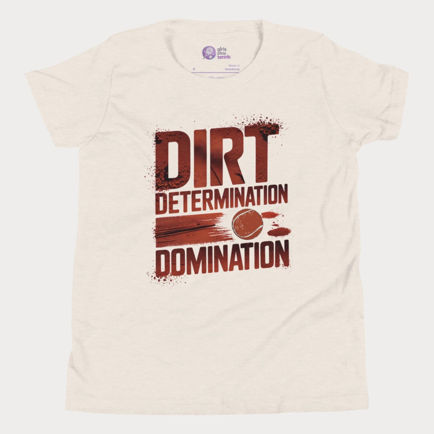 Beige tennis T-shirt featuring bold typography reading "Dirt, Determination, Domination" in clay-red tones, with a graphic of a tennis ball streaking across the design.