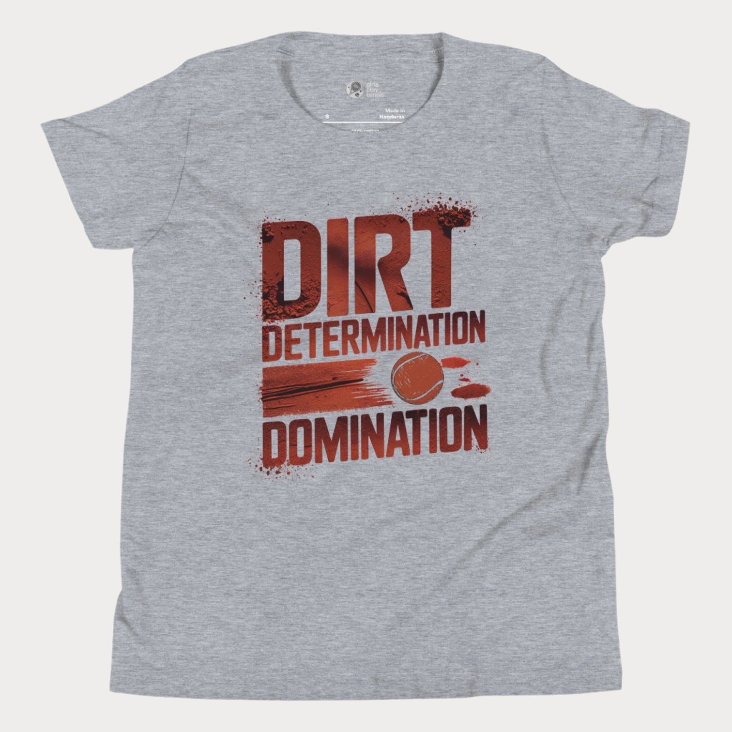 Grey tennis T-shirt featuring bold typography reading "Dirt, Determination, Domination" in clay-red tones, with a graphic of a tennis ball streaking across the design.