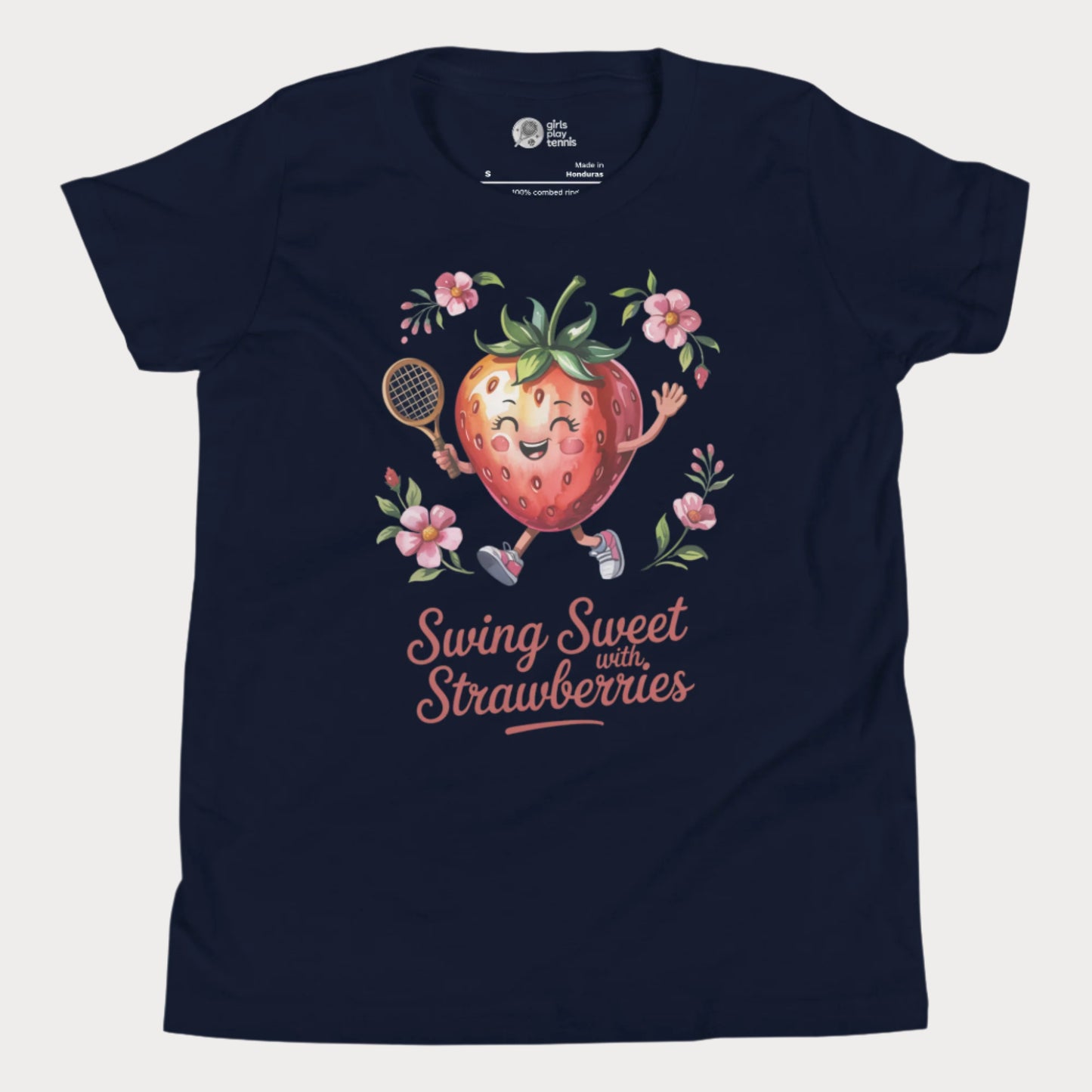 Navy girls tennis t-shirt with a smiling strawberry holding a tennis racket surrounded by pink flowers and the phrase ‘Swing Sweet with Strawberries’