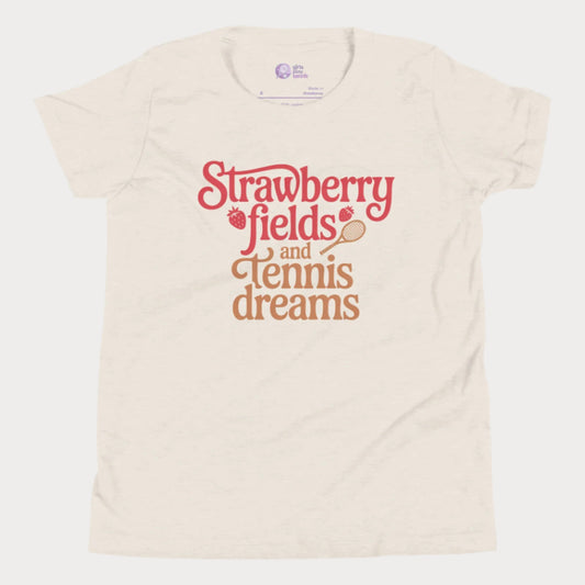 Beige girls tennis t-shirt with retro text that reads ‘Strawberry fields and tennis dreams’ with tennis and strawberry icons.