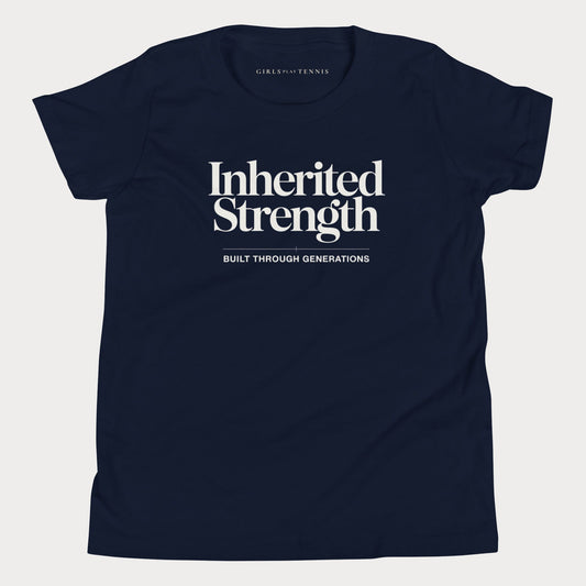 A navy blue short-sleeve t-shirt with 'Inherited Strength' printed in white serif text on the chest, with 'BUILT THROUGH GENERATIONS' underneath. The inner neck label shows the brand 'GIRLS PLAY TENNIS'.
