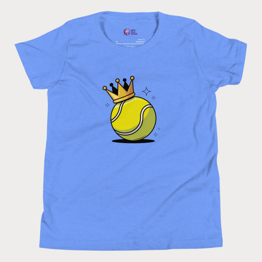 A blue girls’ tennis t-shirt featuring a bold yellow tennis ball with a golden crown perched on top. This playful design celebrates young girls who rule the court with power and personality.