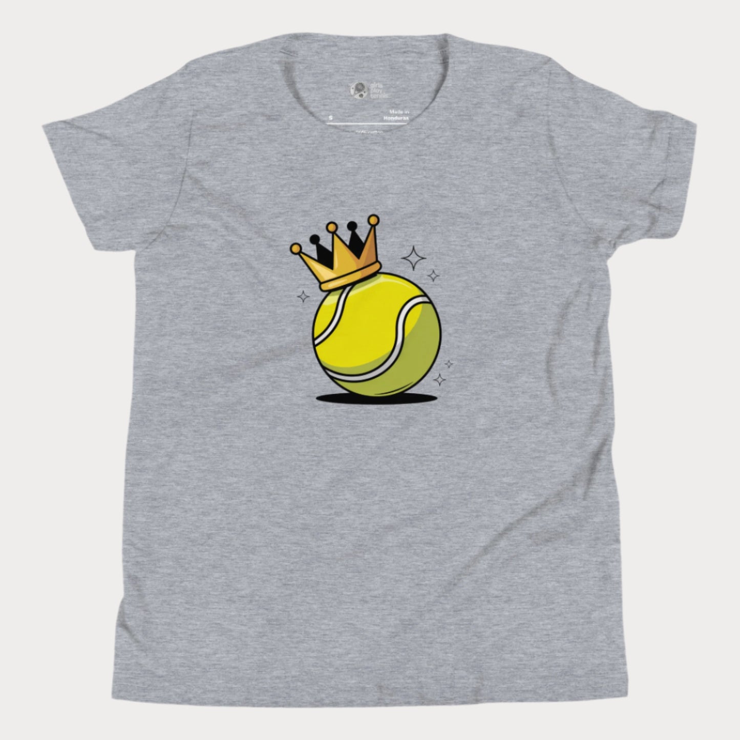 A heather grey girls’ tennis t-shirt featuring a bold yellow tennis ball with a golden crown perched on top. This playful design celebrates young girls who rule the court with power and personality.