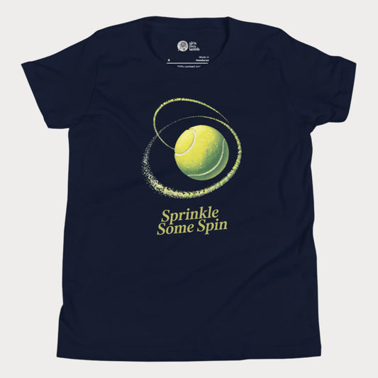 Navy girls tennis t-shirt with a spinning yellow tennis ball and the phrase “Sprinkle Some Spin” in bold yellow text