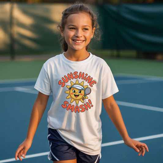 Young girl wearing a white Sunshine Smash kids tennis t-shirt with smiling sun holding tennis racket for toddlers and youth