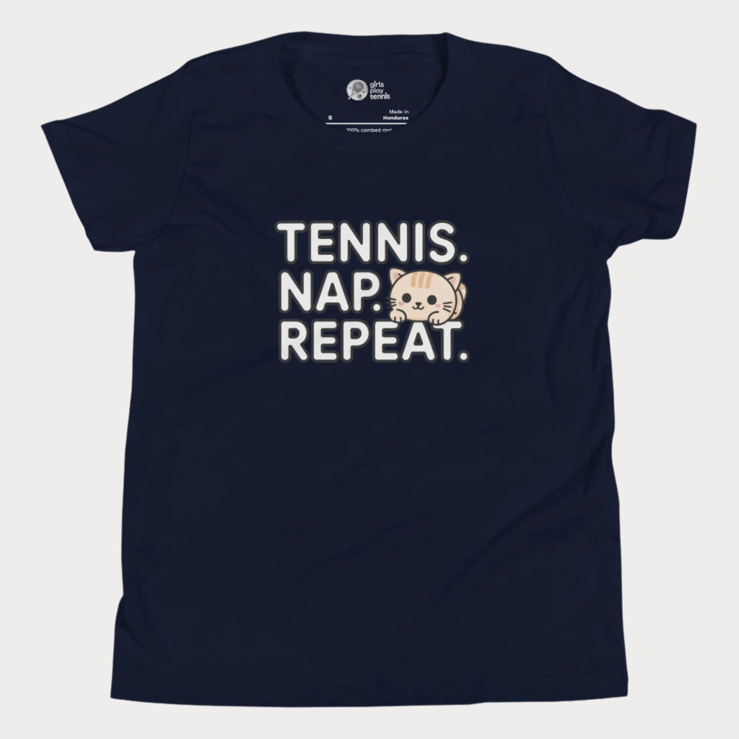 Navy kids tennis t-shirt with “Tennis. Nap. Repeat.” text and a cute cartoon cat illustration, part of the Girls Play Tennis apparel line.