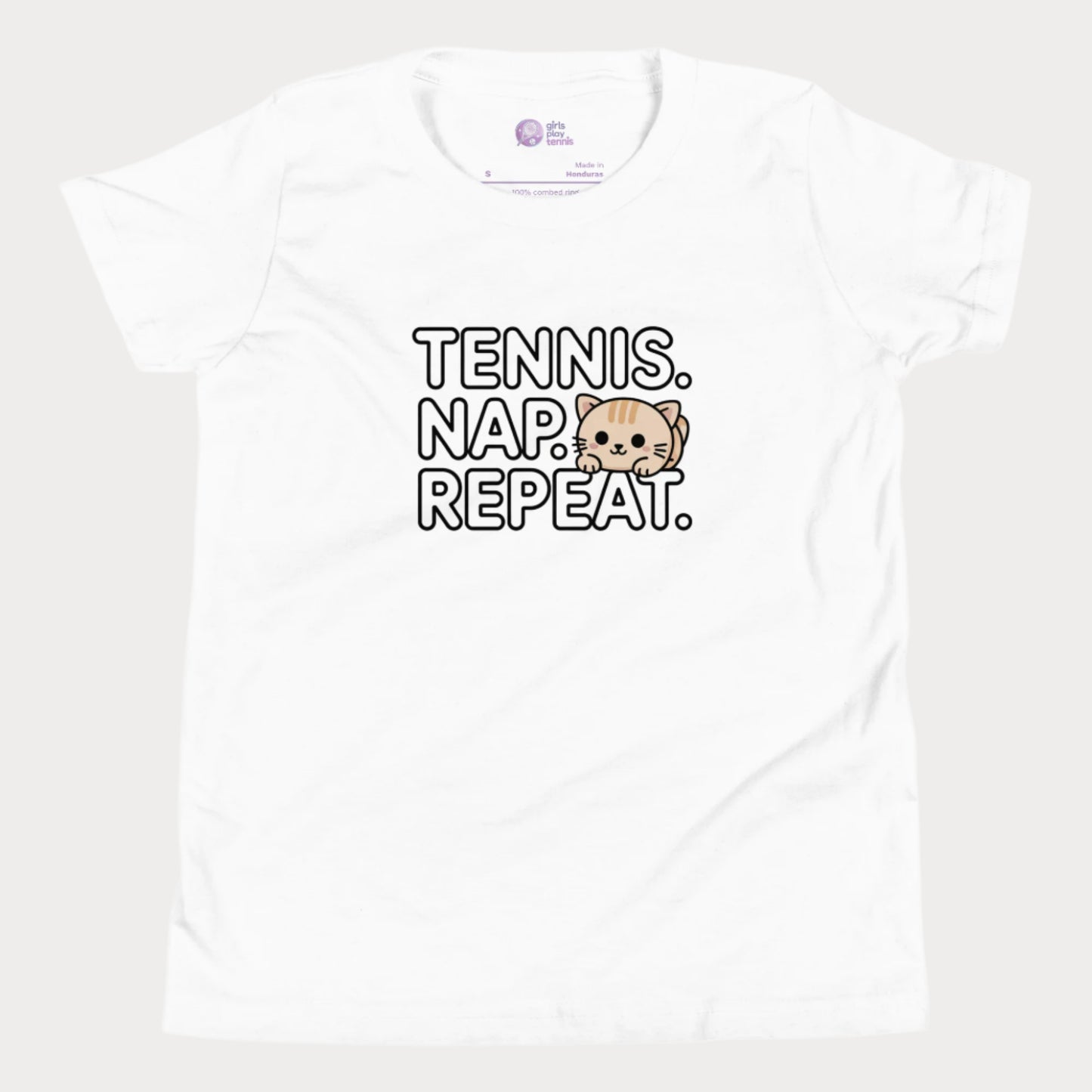 White kids tennis t-shirt with “Tennis. Nap. Repeat.” text and a cute cartoon cat illustration, part of the Girls Play Tennis apparel line.