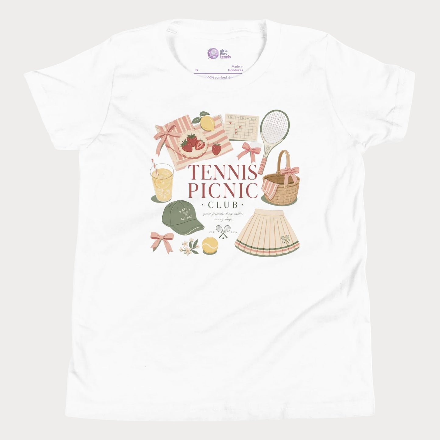 Girls tennis tee featuring picnic-inspired tennis lifestyle artwork with strawberries, lemonade, bows, and pleated skirt details