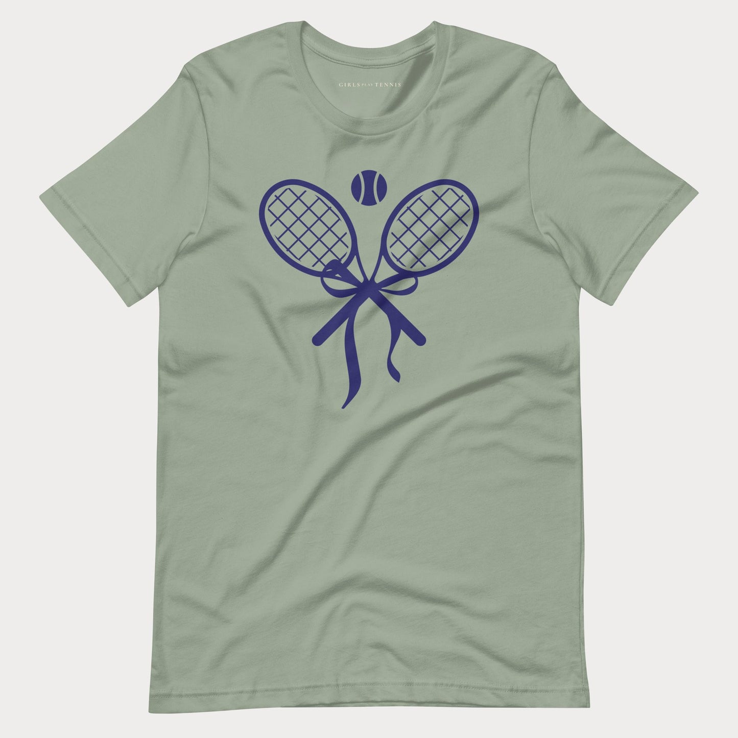 A sage green short-sleeve crewneck tennis t-shirt featuring a dark blue graphic of two crossed tennis rackets tied with a bow, with a tennis ball above them.