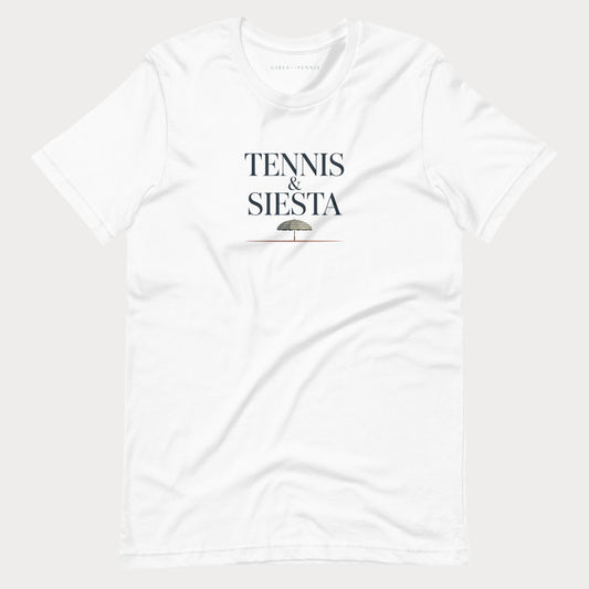 A white short-sleeve crewneck women's lifestyle t-shirt with 'TENNIS & SIESTA' printed in black serif letters on the chest, with a small umbrella graphic underneath, shown against a light gray background.