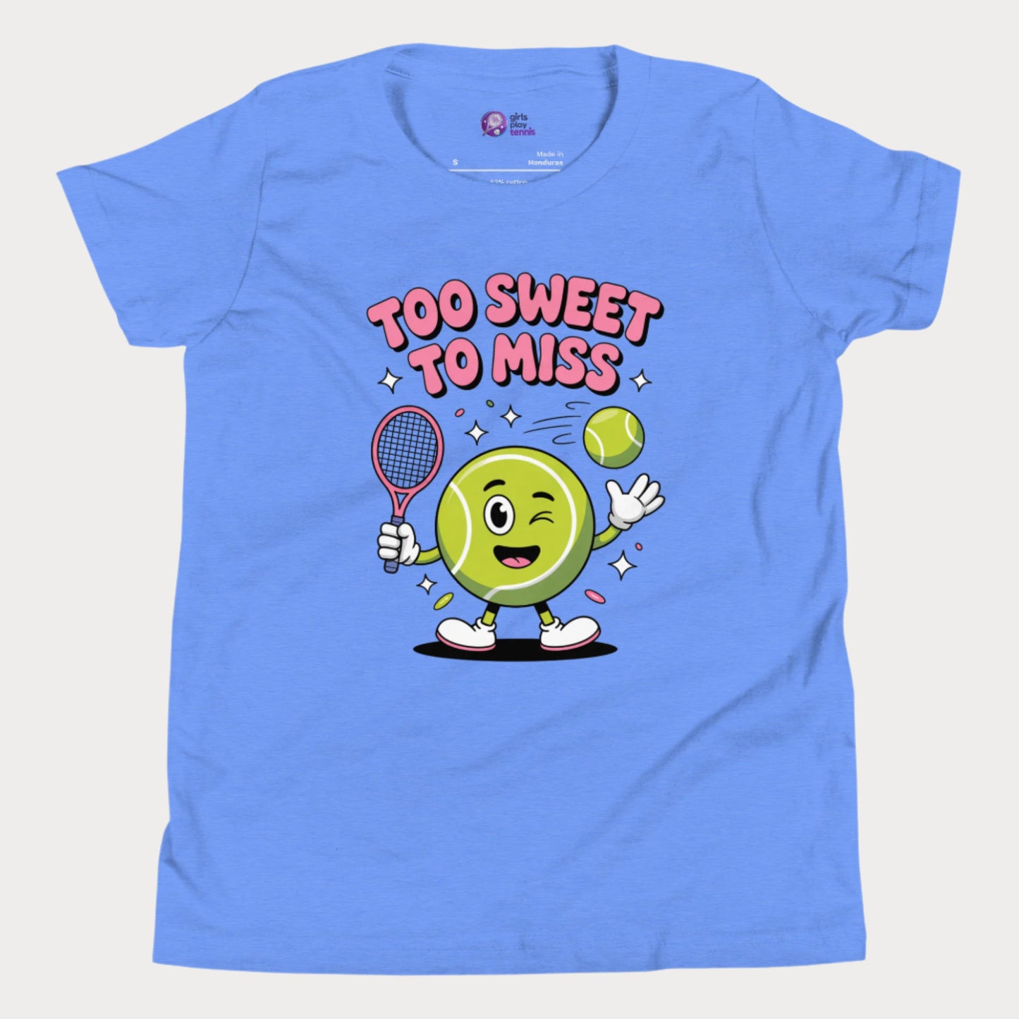 Blue girls tennis t-shirt with a winking cartoon tennis ball holding a racket and the slogan “Too Sweet To Miss” in bold letters.