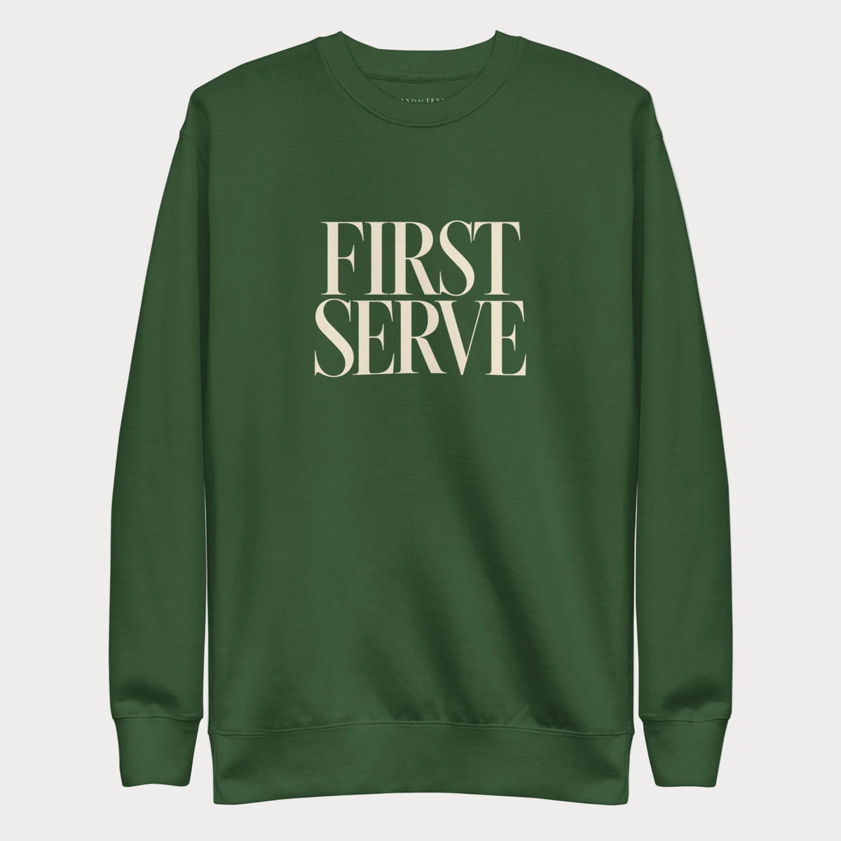 Forest green First Serve women's tennis crewneck sweatshirt with stacked cream capitals reading First Serve
