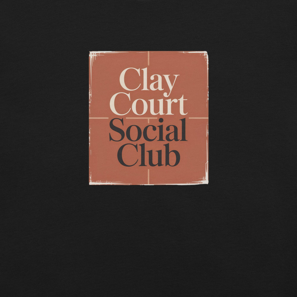 Close-up of the clay-red square graphic on a black Clay Court Social Club women's tennis T-shirt