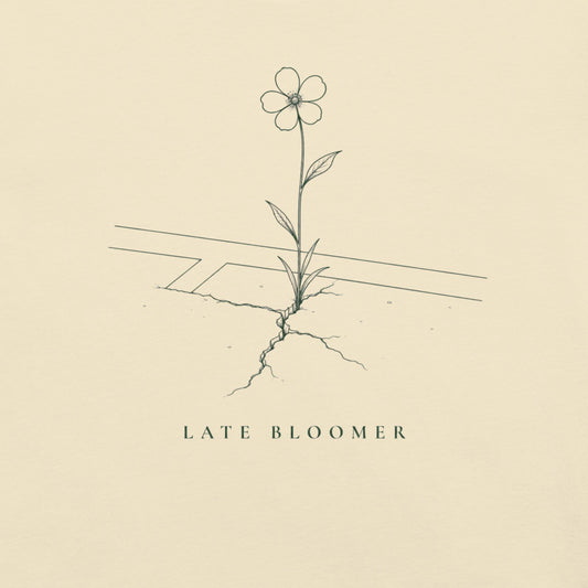 Close-up of the Late Bloomer flower and court line drawing on a cream tee