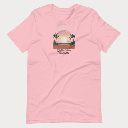 A light pink short-sleeve crewneck t-shirt featuring a retro-style graphic of a sunset over a tropical beach with palm trees and the text 'Golden Hour Mediterranean' printed on the chest, displayed against a light gray background.
