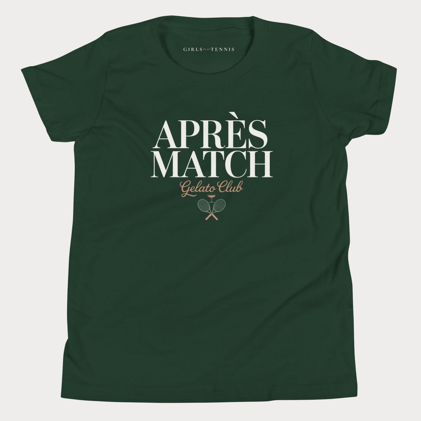 A dark green short-sleeve girls tennis t-shirt with a white and gold graphic on the front reading 'APRÈS MATCH Gelato Club' with crossed tennis rackets, shown on a light gray background.