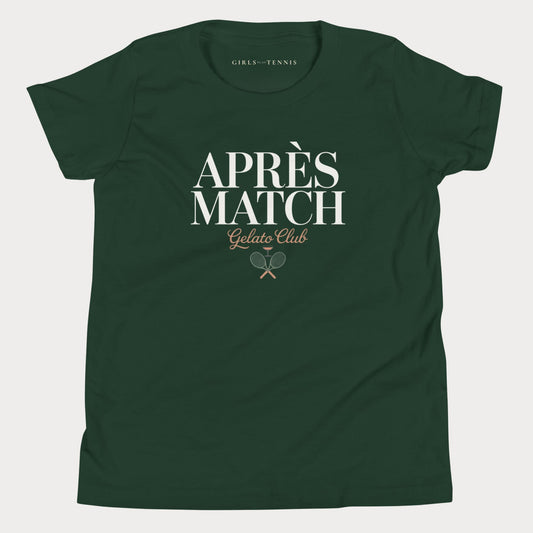 A dark green short-sleeve girls tennis t-shirt with a white and gold graphic on the front reading 'APRÈS MATCH Gelato Club' with crossed tennis rackets, shown on a light gray background.