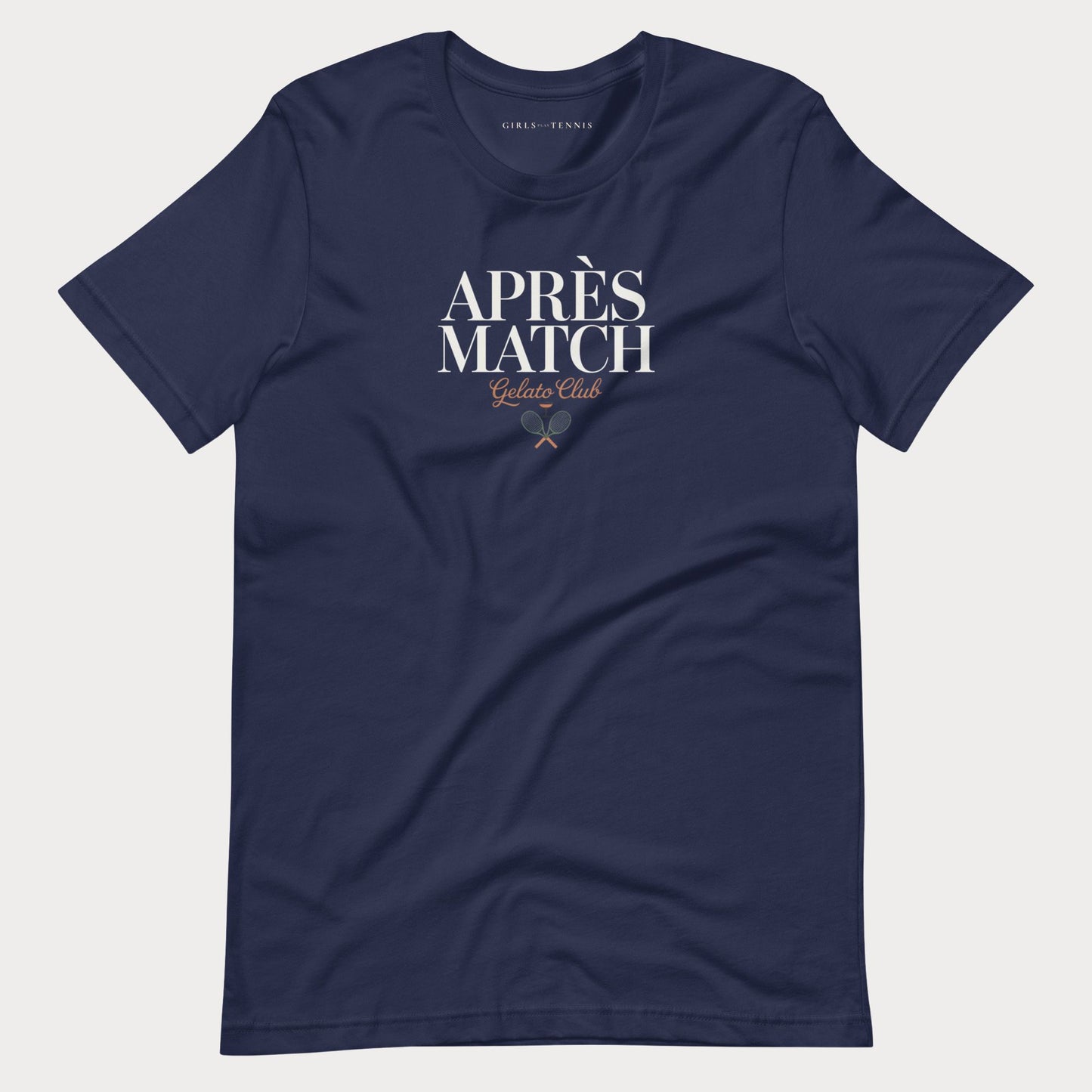 A navy blue short-sleeve women's tennis t-shirt with 'APRÈS MATCH Gelato Club' printed in white and gold on the chest, displayed flat against a light gray background.