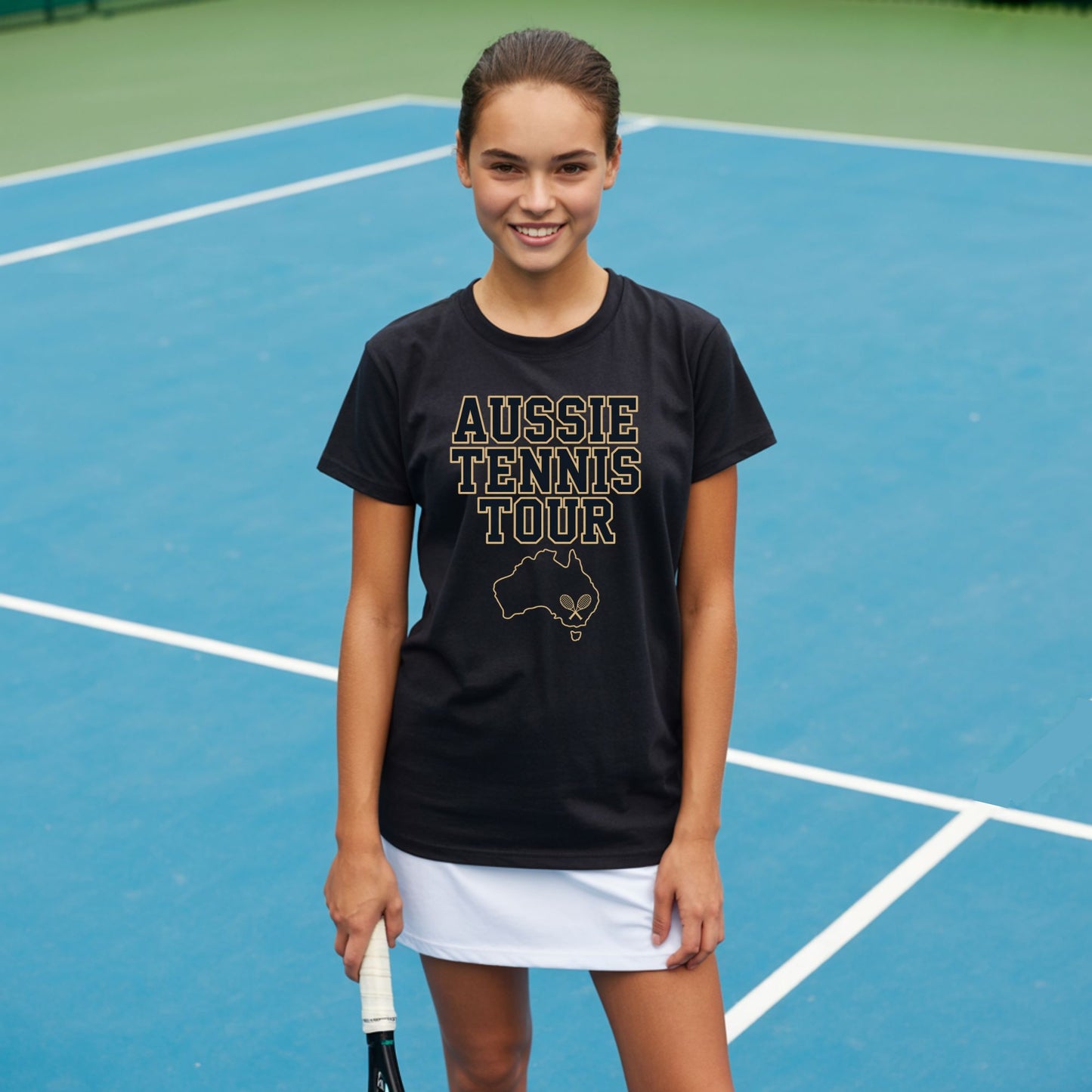 Teenage girl standing on a tennis courts and wearing an Aussie Tennis Tour t-shirt with Australia outline and tennis graphic for players and fans.