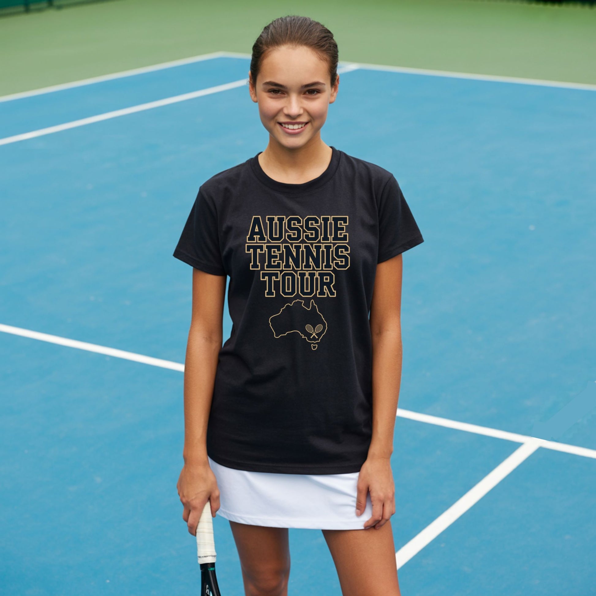 Teenage girl standing on a tennis courts and wearing an Aussie Tennis Tour t-shirt with Australia outline and tennis graphic for players and fans.