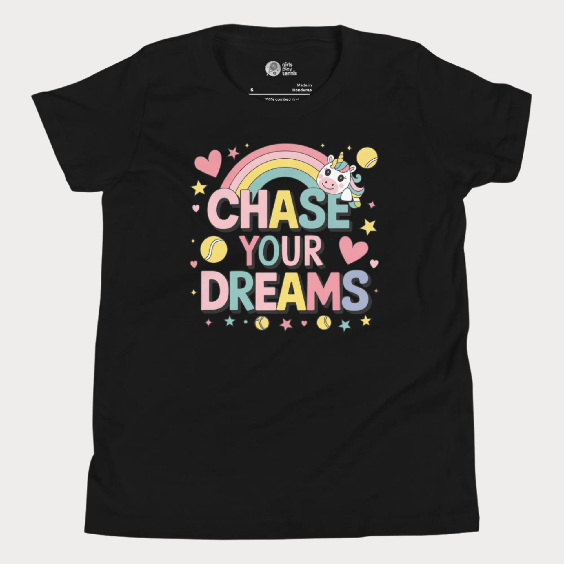 Adorable girls' black tennis t-shirt featuring a cute unicorn, colorful rainbow, and "Chase Your Dreams" slogan with tennis ball accents.