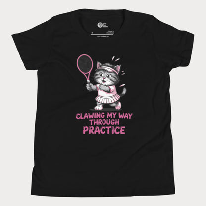 A black girls’ tennis t-shirt featuring a determined gray kitten in a pink tennis outfit holding a pink tennis racket. The kitten is sweating and focused, with the phrase “Clawing My Way Through Practice” in bold pink lettering underneath. 