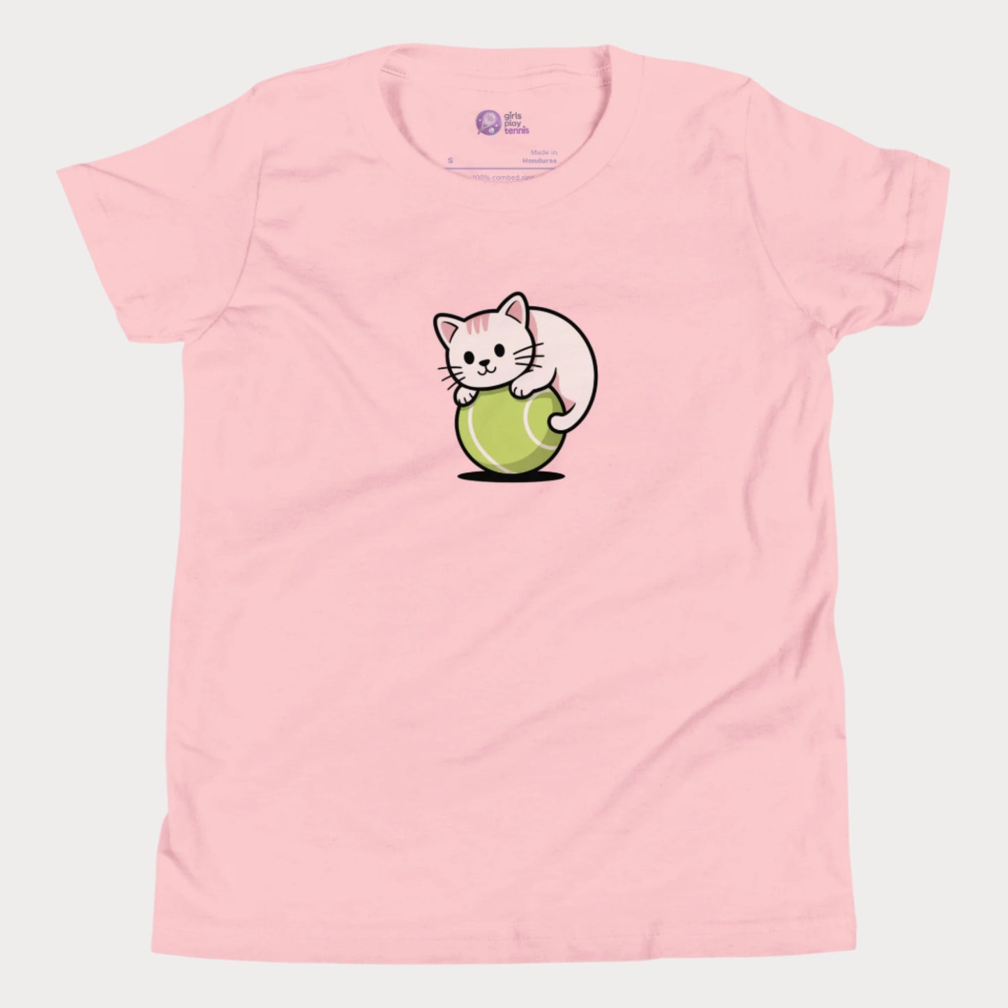 A light pink girls’ tennis t-shirt featuring a cute kitten playfully curled around a bright green tennis ball in the center of the chest — a fun and whimsical design perfect for young tennis players who love animals and the game.