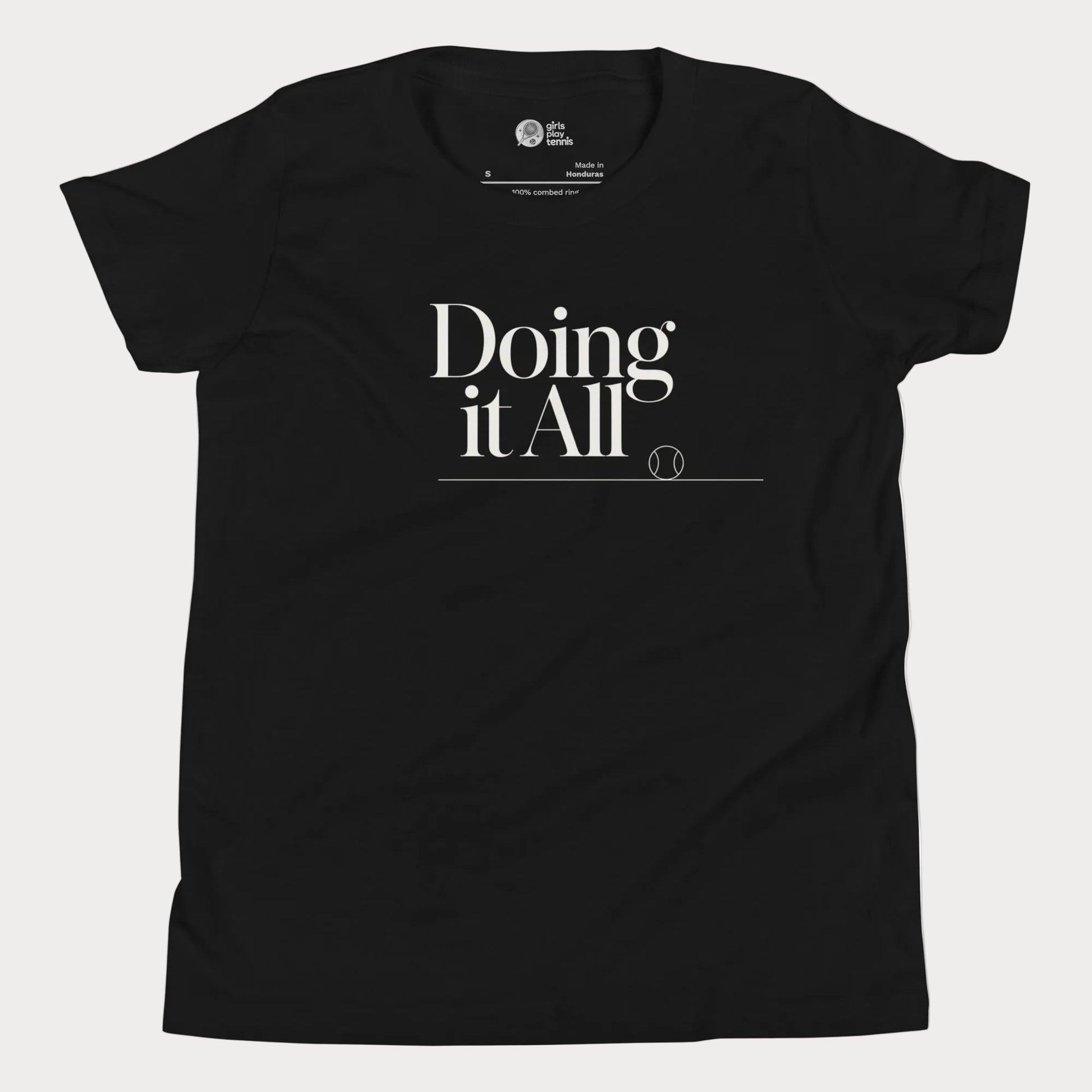 Doing It All tennis tee in black with minimalist white typography and tennis detail for women and girls
