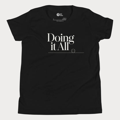 Doing It All tennis tee in black with minimalist white typography and tennis detail for women and girls