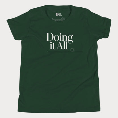 Doing It All tennis tee in forest green with minimalist white typography and tennis detail for women and girls