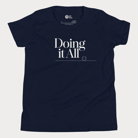Doing It All tennis tee in navy with minimalist white typography and tennis detail for women and girls.