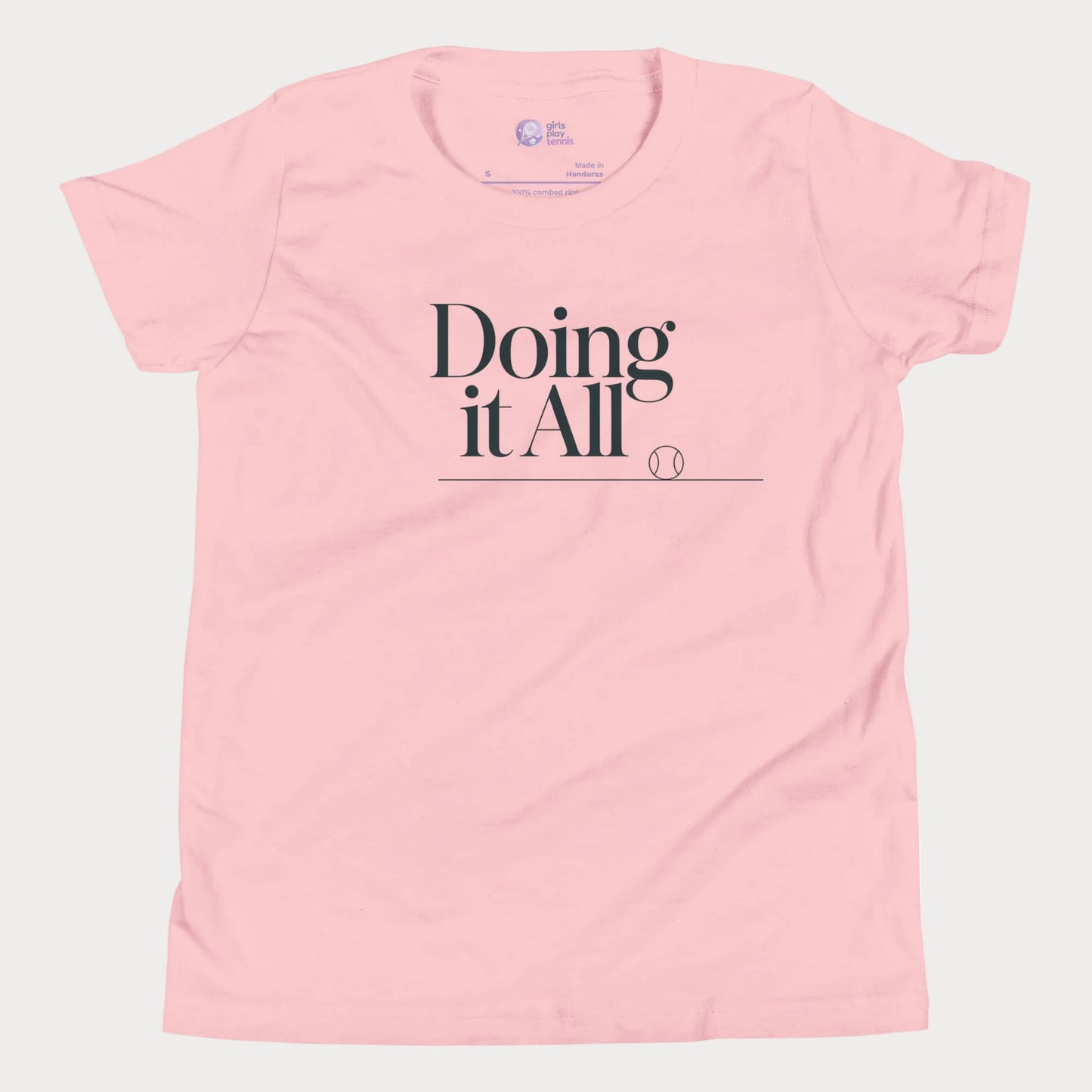 Doing It All tennis tee in pink with minimalist white typography and tennis detail for women and girls