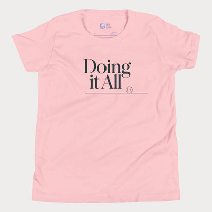 Doing It All tennis tee in pink with minimalist white typography and tennis detail for women and girls