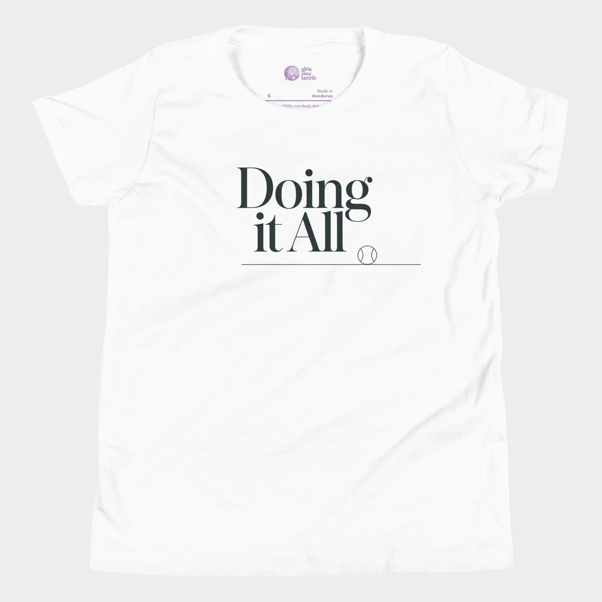 Doing It All tennis tee in white with minimalist white typography and tennis detail for women and girls