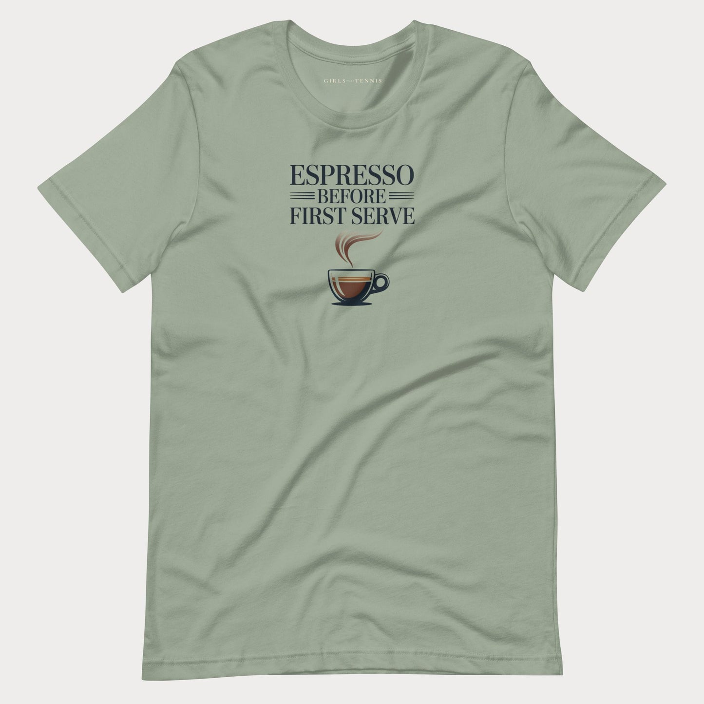 A sage green crewneck tennis lifestyle t-shirt for women with a graphic print that reads 'ESPRESSO BEFORE FIRST SERVE' above a coffee cup illustration, displayed flat against a light gray background.