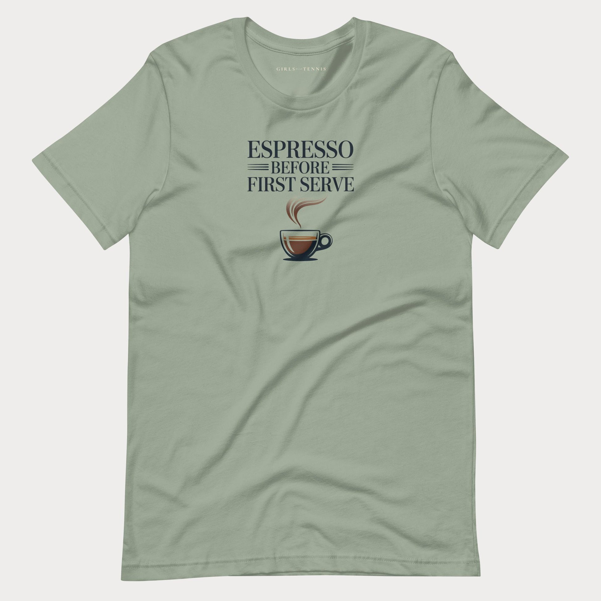 A sage green crewneck tennis lifestyle t-shirt for women with a graphic print that reads 'ESPRESSO BEFORE FIRST SERVE' above a coffee cup illustration, displayed flat against a light gray background.