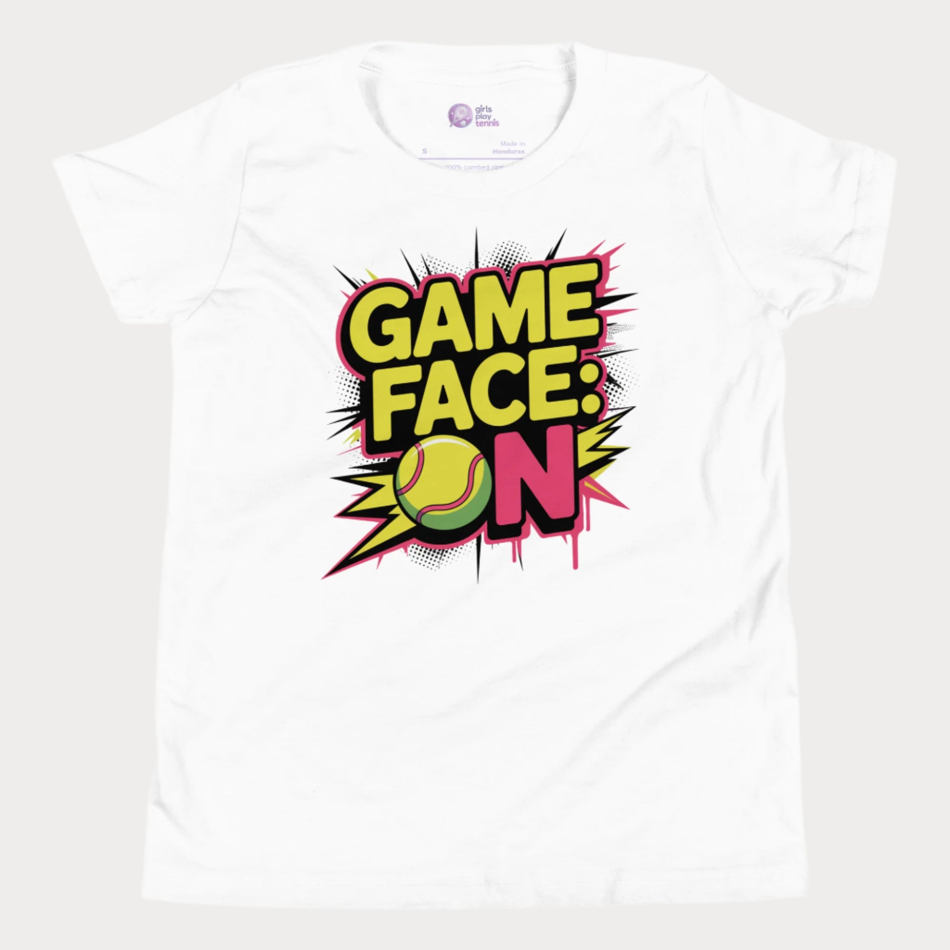 White kids tennis t-shirt with bold comic-style "Game Face: ON" graphic and tennis ball illustration.