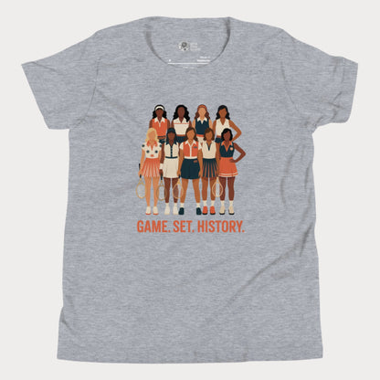 Grey kids tennis t-shirt with illustration of 9 vintage-style female tennis players and the phrase “Game. Set. History.” honoring women’s tennis pioneers.