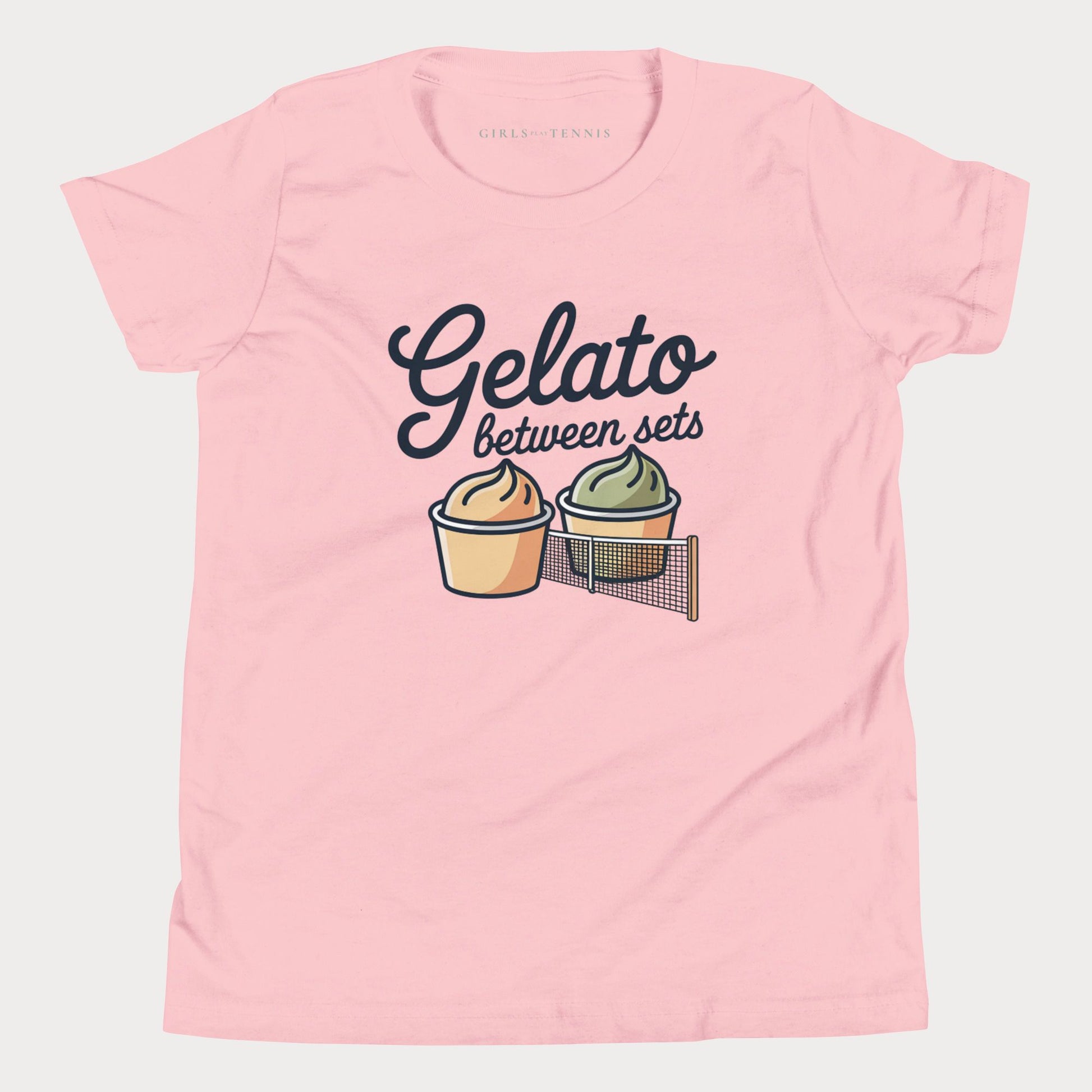 A light pink short-sleeve t-shirt with a graphic print that reads 'Gelato between sets' above two illustrated gelato cups, shown on a light gray background.