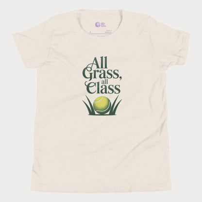Beige girls’ tennis T-shirt with green text “All Grass, All Class” and tennis ball in grass graphic.