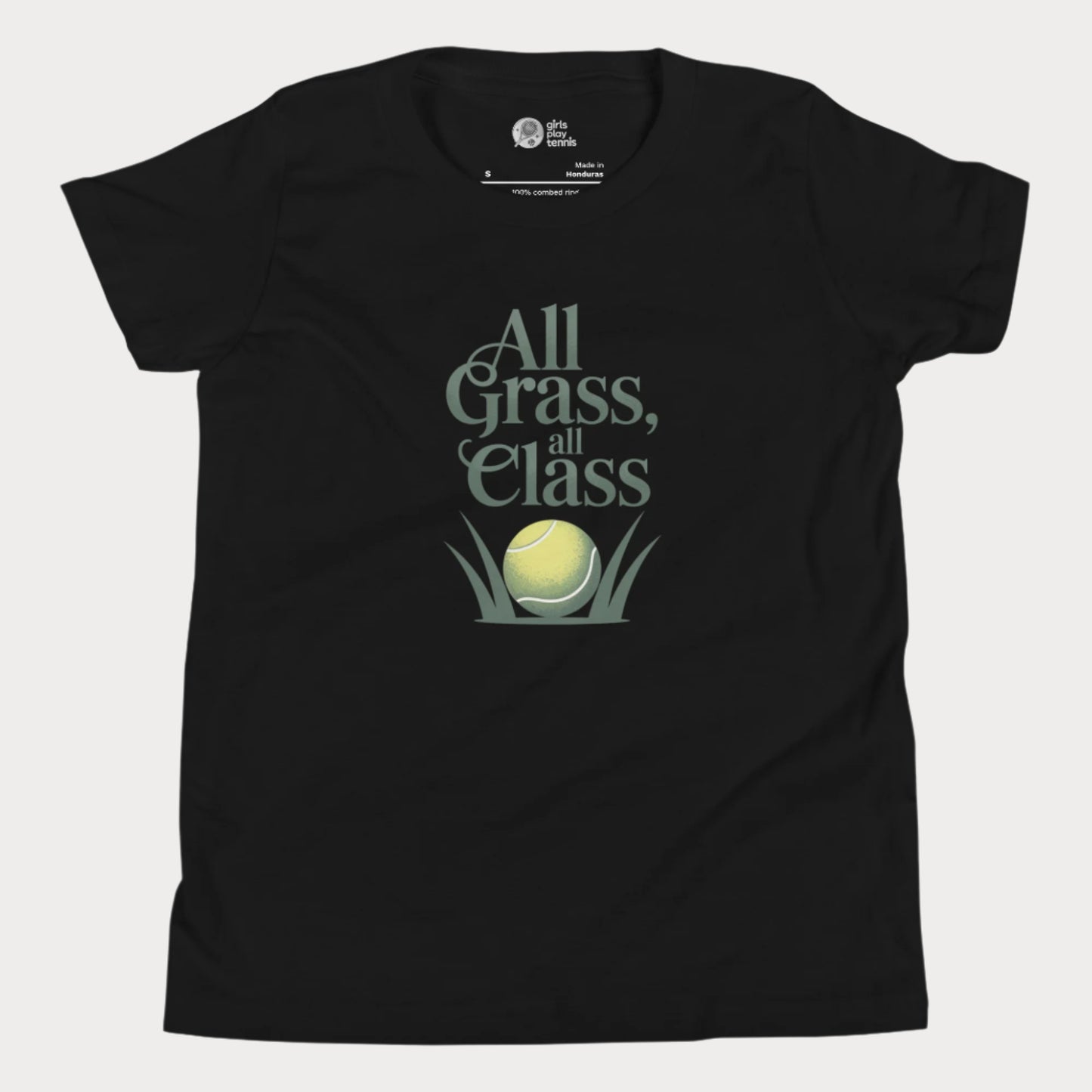 Black girls’ tennis T-shirt with green text “All Grass, All Class” and tennis ball in grass graphic.