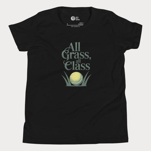 Black girls’ tennis T-shirt with green text “All Grass, All Class” and tennis ball in grass graphic.