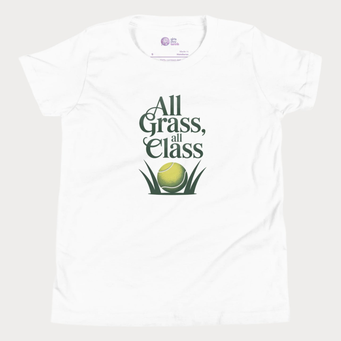 White girls’ tennis T-shirt with green text “All Grass, All Class” and tennis ball in grass graphic.