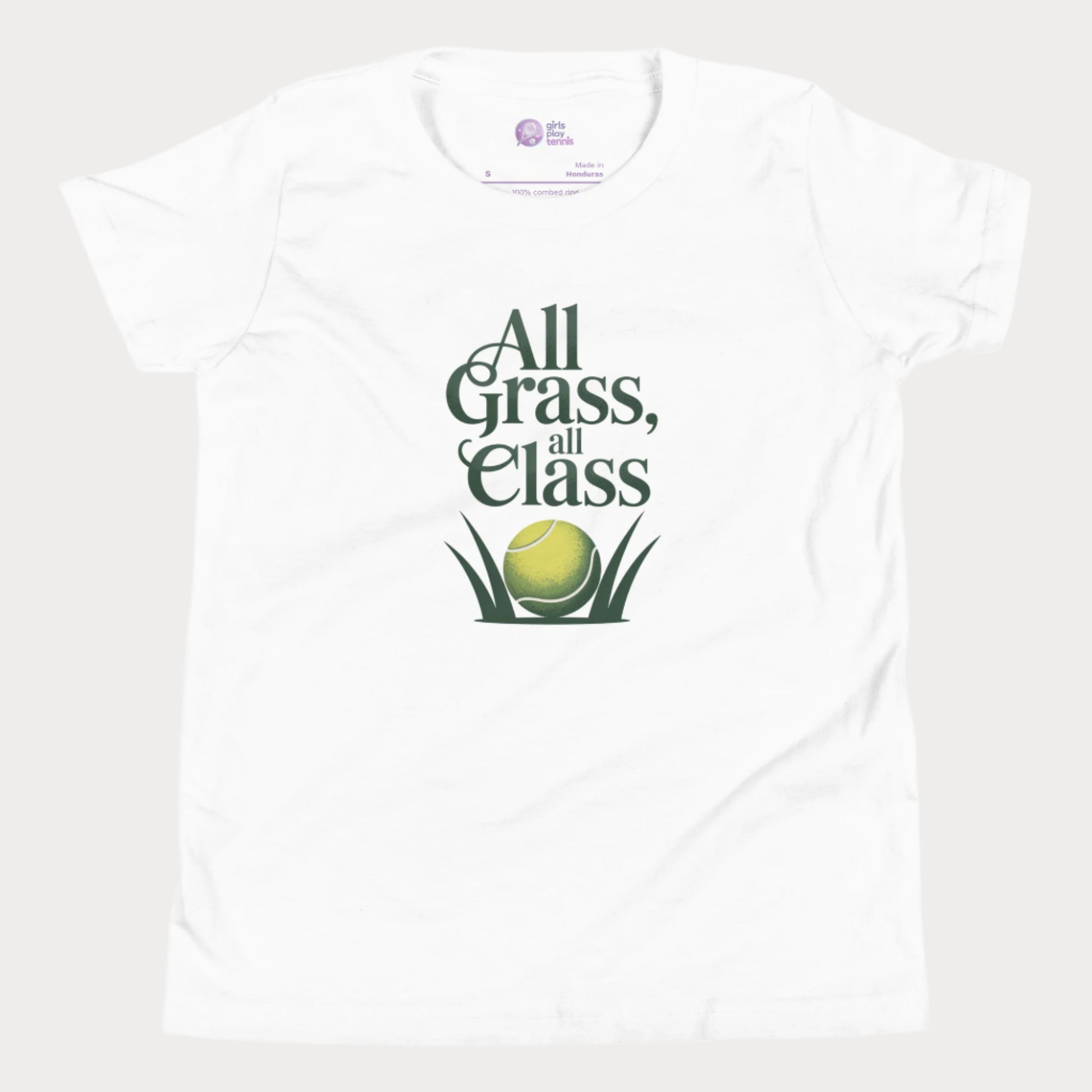 White girls’ tennis T-shirt with green text “All Grass, All Class” and tennis ball in grass graphic.